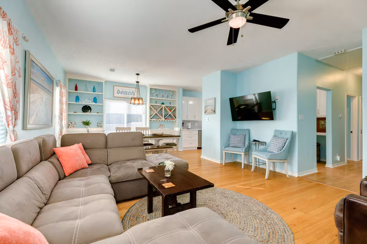 Bright coastal living room with sectional sofa and beach decor